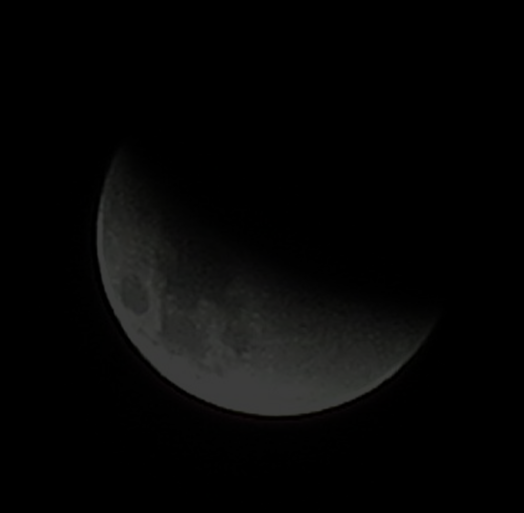 A photograph of a Supermoon during a partial lunar eclipse, so around 60% of it is hidden by shadow.